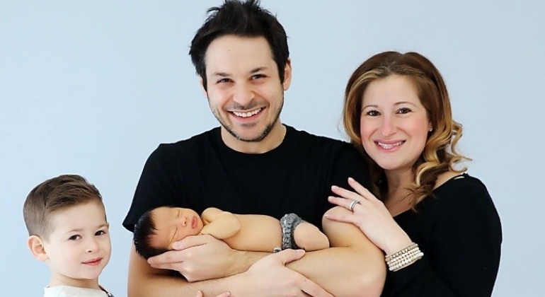 parents posing together with child and baby