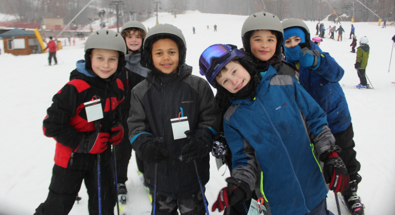 boys in ski gear smiling for the camera