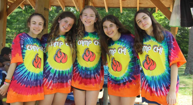 group of girls wearing matching tie dye Camp Chi shirts