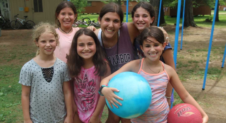 campers holding bouncy balls smiling for the camera