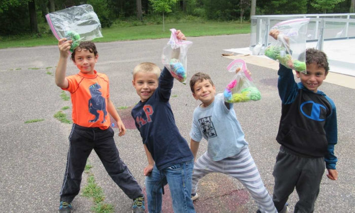 campers posing with their bags of tie dyes