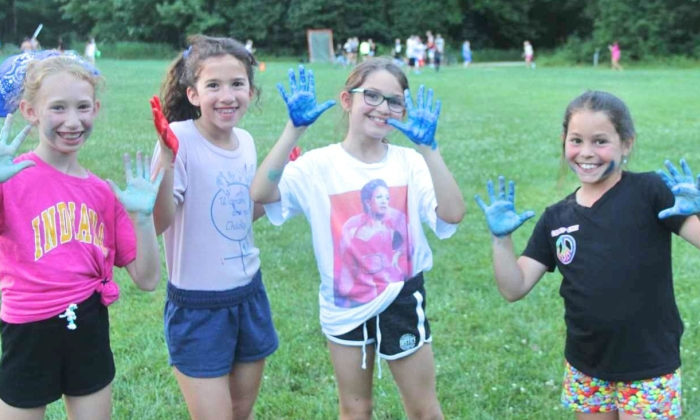 campers showing off their colorful hands after an activity