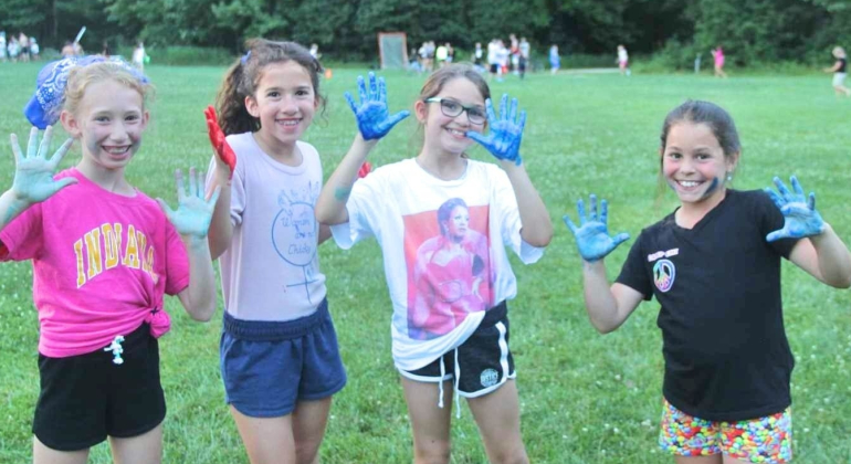 campers showing off their colorful hands after an activity