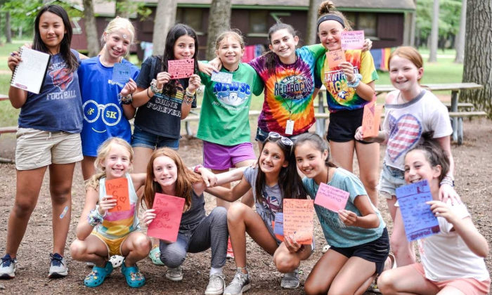 a group of girls posing with hand-made cards
