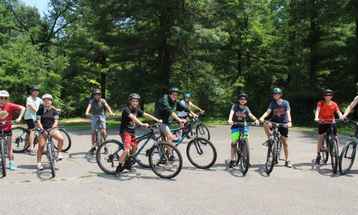 boy campers riding bikes together