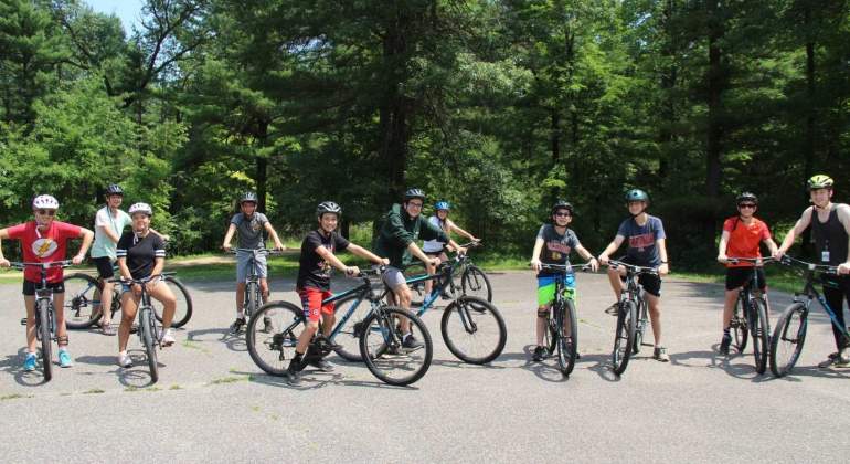 boy campers riding bikes together