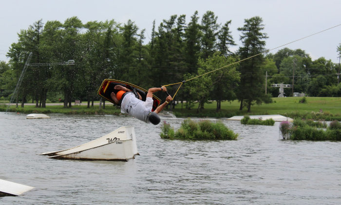 camper doing a cool trick on water skis