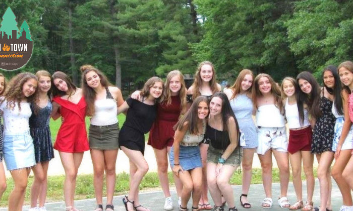 group of girls dressed up for Shabbat posing for a picture