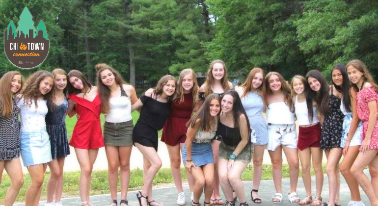 group of girls dressed up for Shabbat posing for a picture
