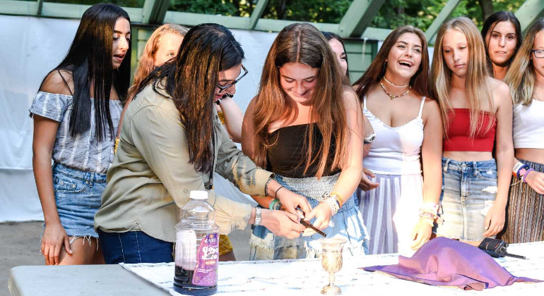 girls lighting candles and celebrating Shabbat together