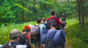 campers head into the woods for an overnight camping trip