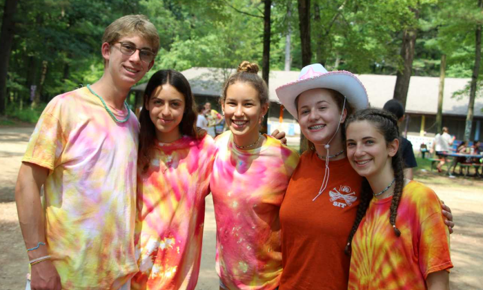 group of campers all dressed in orange and pink tie dye