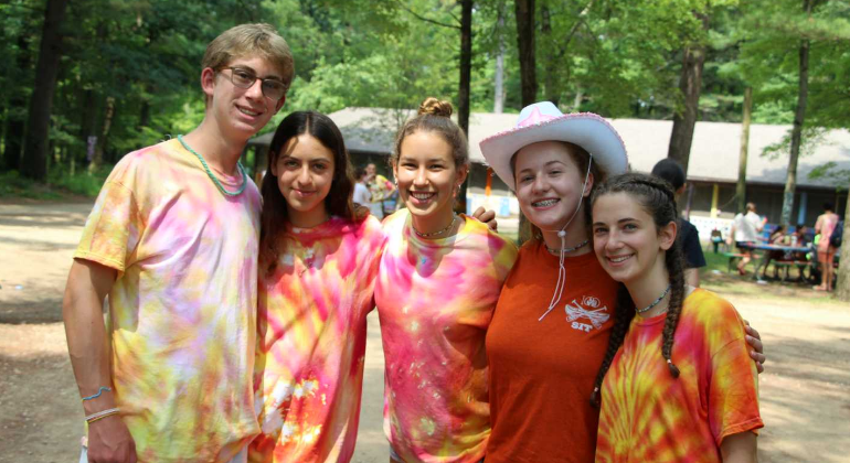 group of campers all dressed in orange and pink tie dye
