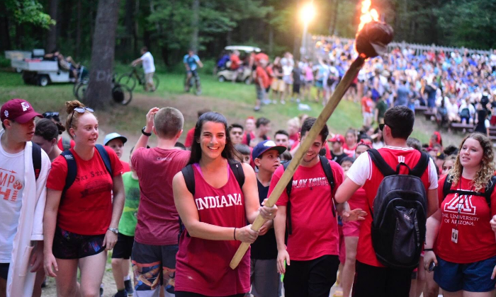 girl carrying a giant torch