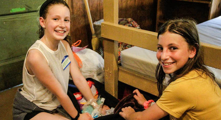 campers unpacking together in their cabin