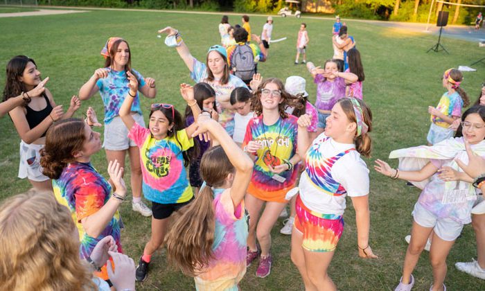 chi campers wearing tie dye and dancing