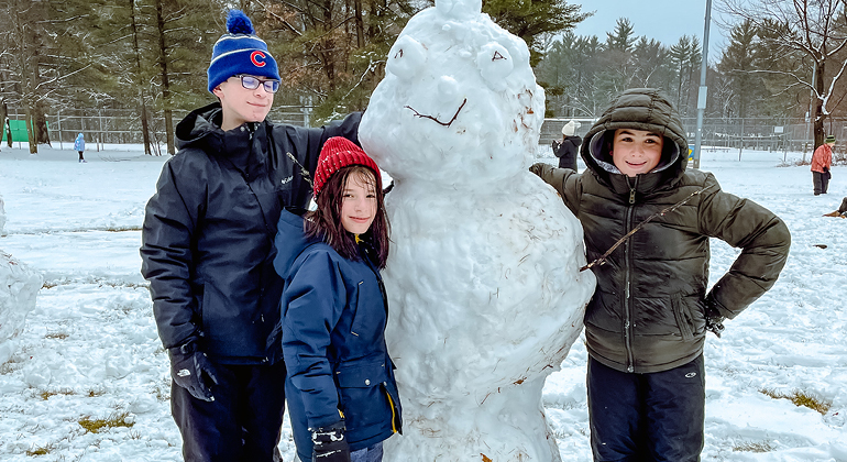 campers with snowman
