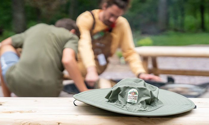 outpost village hat on picnic table